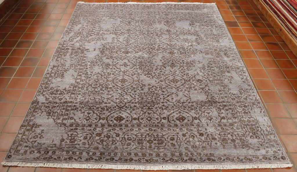 Two tone rug, with a lilac grey background and the design upon it which is a brown shade.  Certain areas of the design have been omitted. to add to the effect.