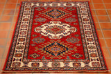Hand knotted in north west Afghanistan this bold Caucasian design has vibrant colourings of red, light and dark blue, gold, and cream. The pile is made from tough Afghan wool and it is woven on to a cotton foundation. This type of rug comes in a wide range of sizes from door mats to room size pieces.