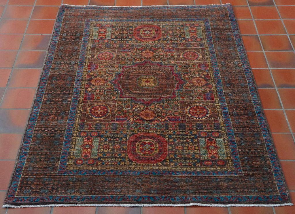 This fine, detailed and delicate Mamluk measures 147 by 101 centimetres.  The electric blue stands out against the mocha shade and really brings the rug to life.   The central medallion is surrounded by an area of decoration consisting of large and small floral details and shapes.  The broad border edges the rug with hints of the blue throughout. 