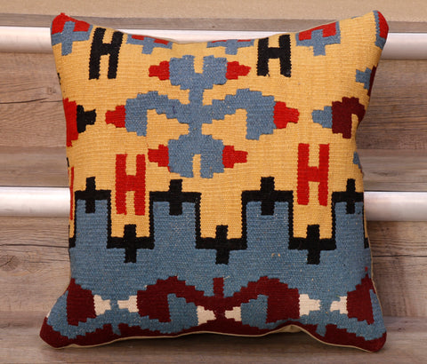 The pieces are often salvaged from old Turkish kilim so the pattern may be cut in unusual and interesting ways.  The decoration is made up of geometric shapes. The brightly coloured Kilim has touches of vibrant reds, blues, yellow, blacks and burgundy which contrast against the other colours on the facing side, whereas the back of the cushion is Faux suede or cotton.