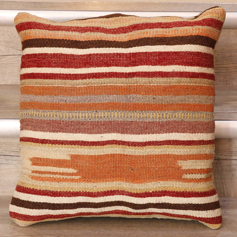 Horilzontal bands of deep red, tan, dark brown, dusky pink, and cream throughout this cushion. 