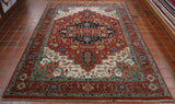 Central ground in russet, within it a black, highly decorated medallion.  Broad border again in russet, with smaller edging borders either side in duck egg.  There is an area of cream, decorated surrounding the central section.  The entire rug is decorated with a stylized, inter connecting flora and fauna pattern. 